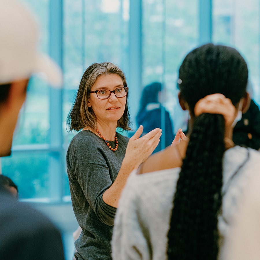 teacher lecturing students in art gallery uhall