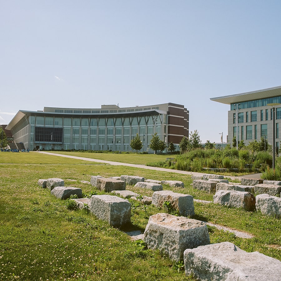 View of campus from the campus center lawn showing the stone benches.