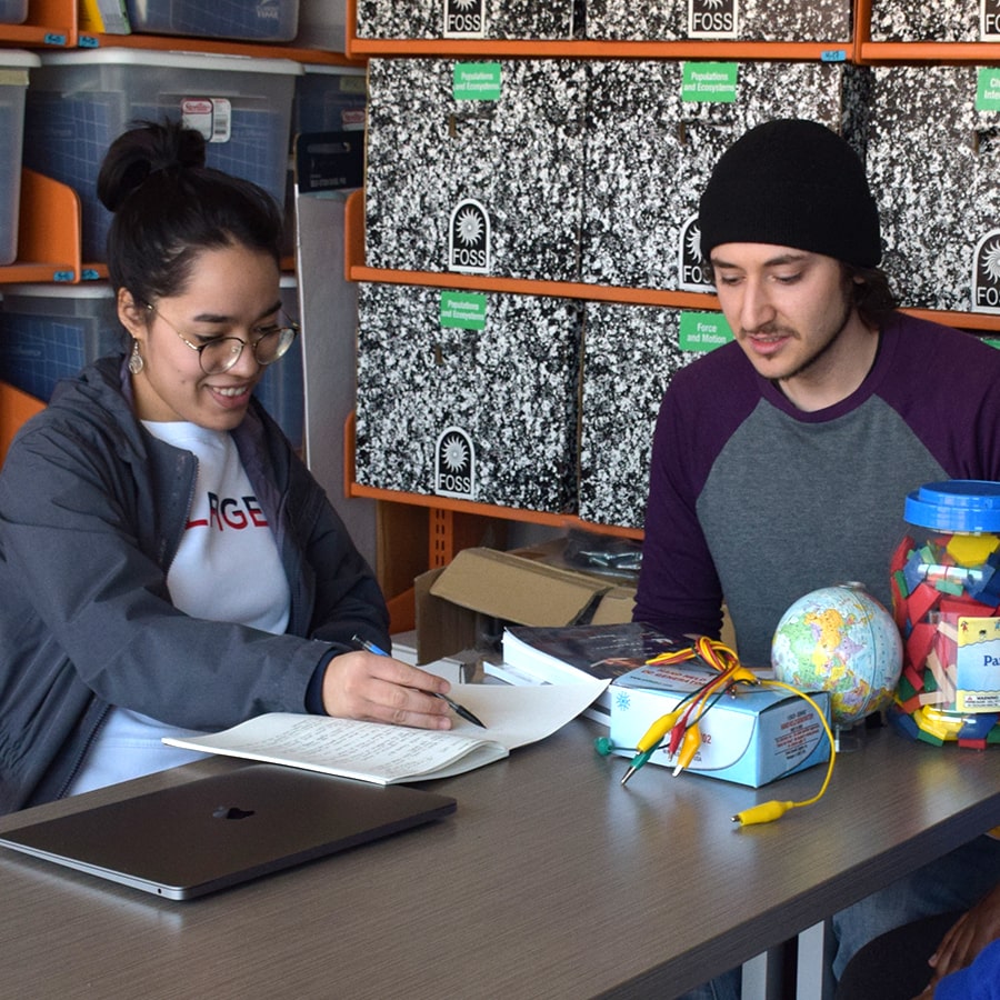 Two students work on lesson plans.