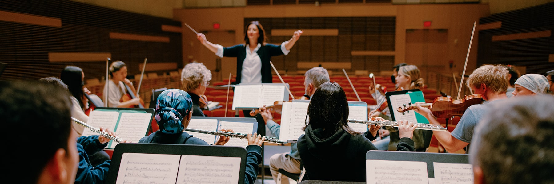 Students rehearse in the orchestra in university hall.