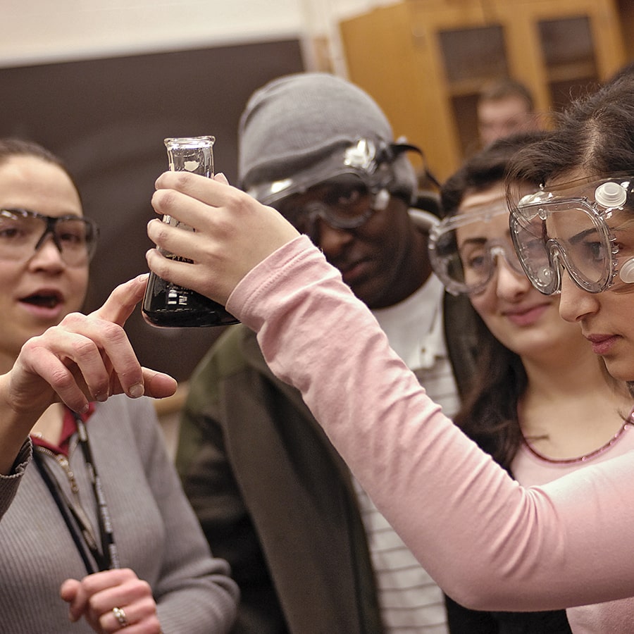 Students hold test tubes.