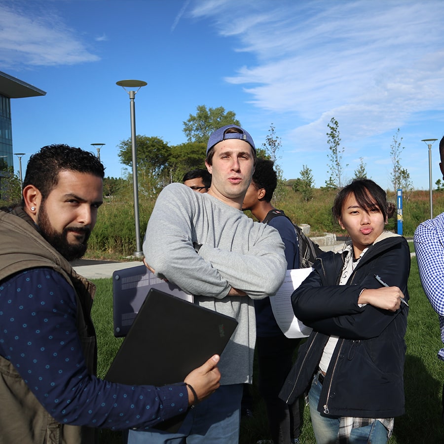 IT students pose on campus center lawn.