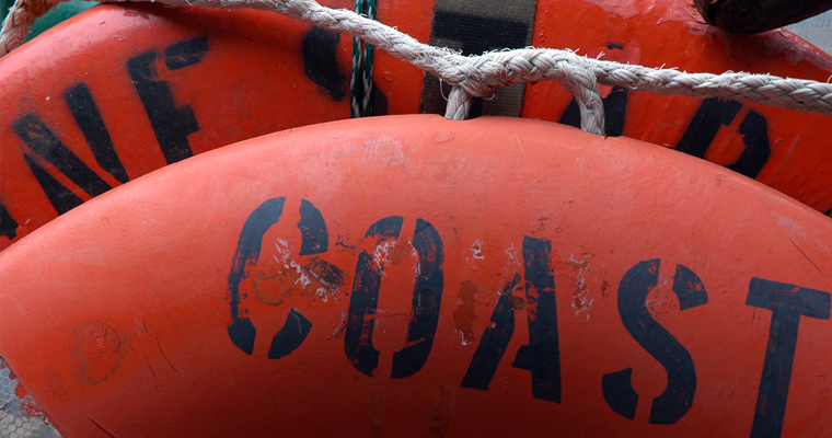 A stack of US Coast Guard life preservers 