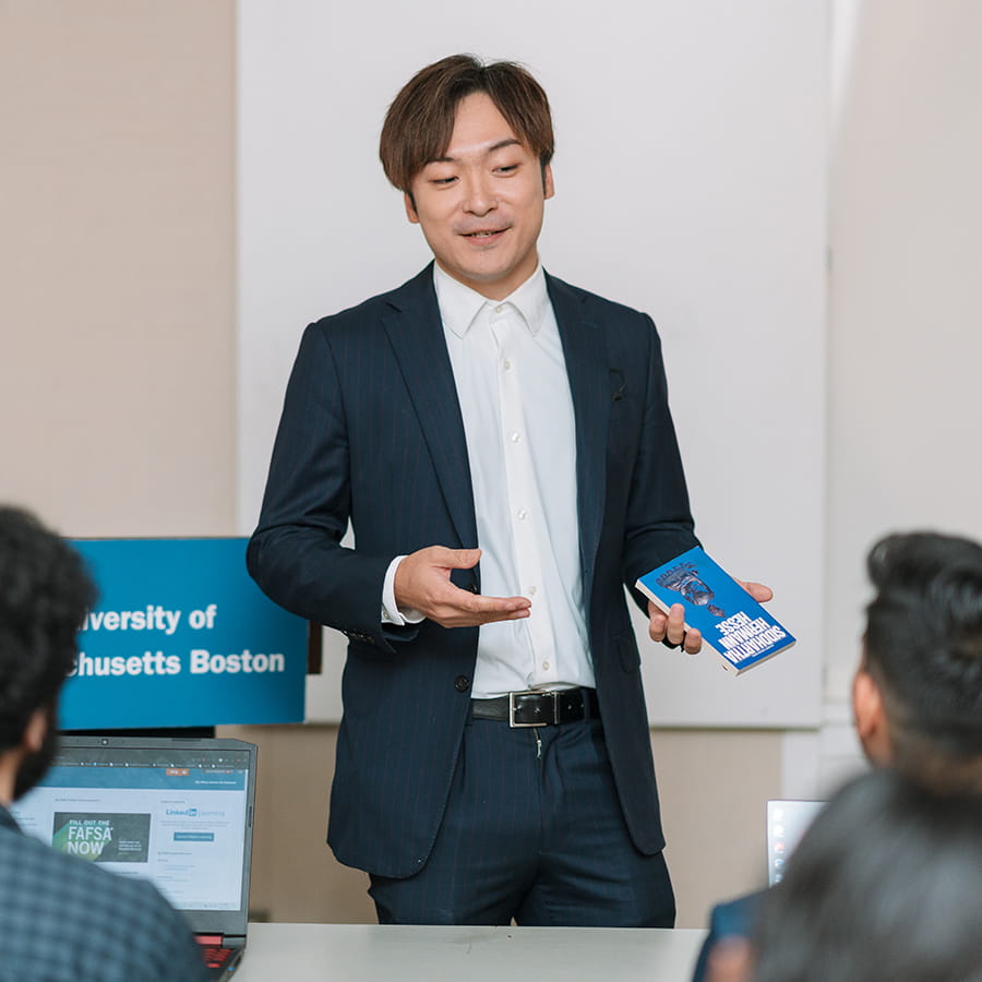 student in formal business attire giving presentation