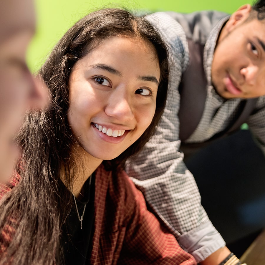 closeup female student interacting with 2 students
