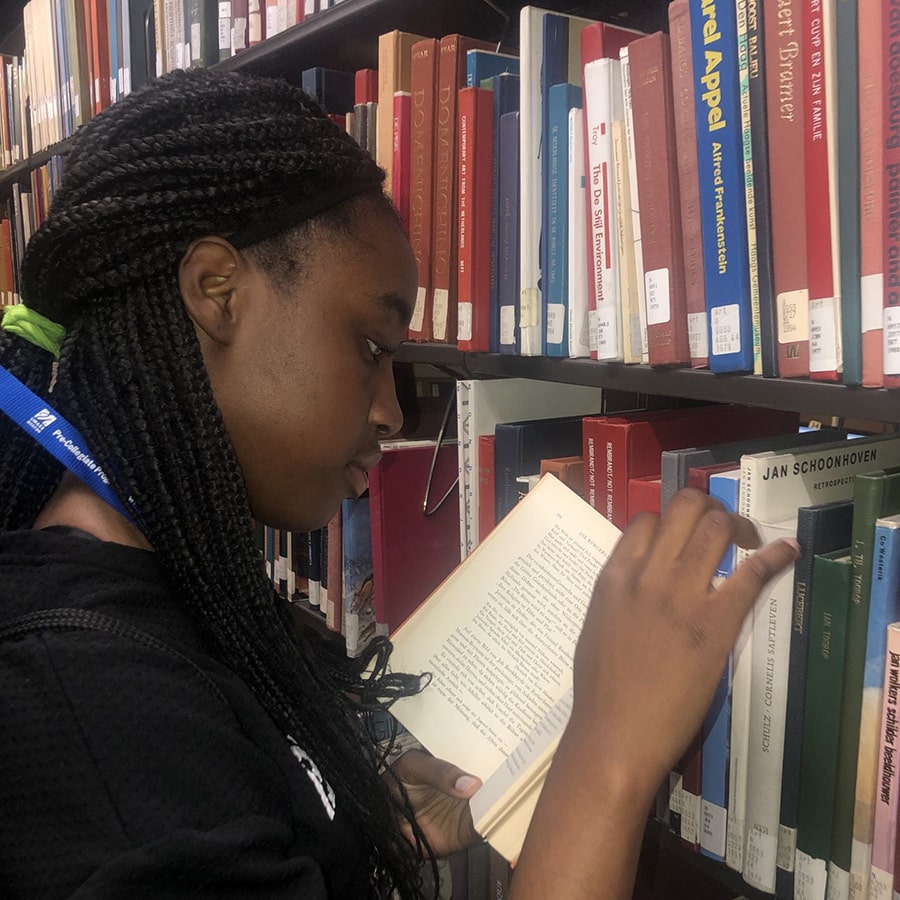 student selecting book in library