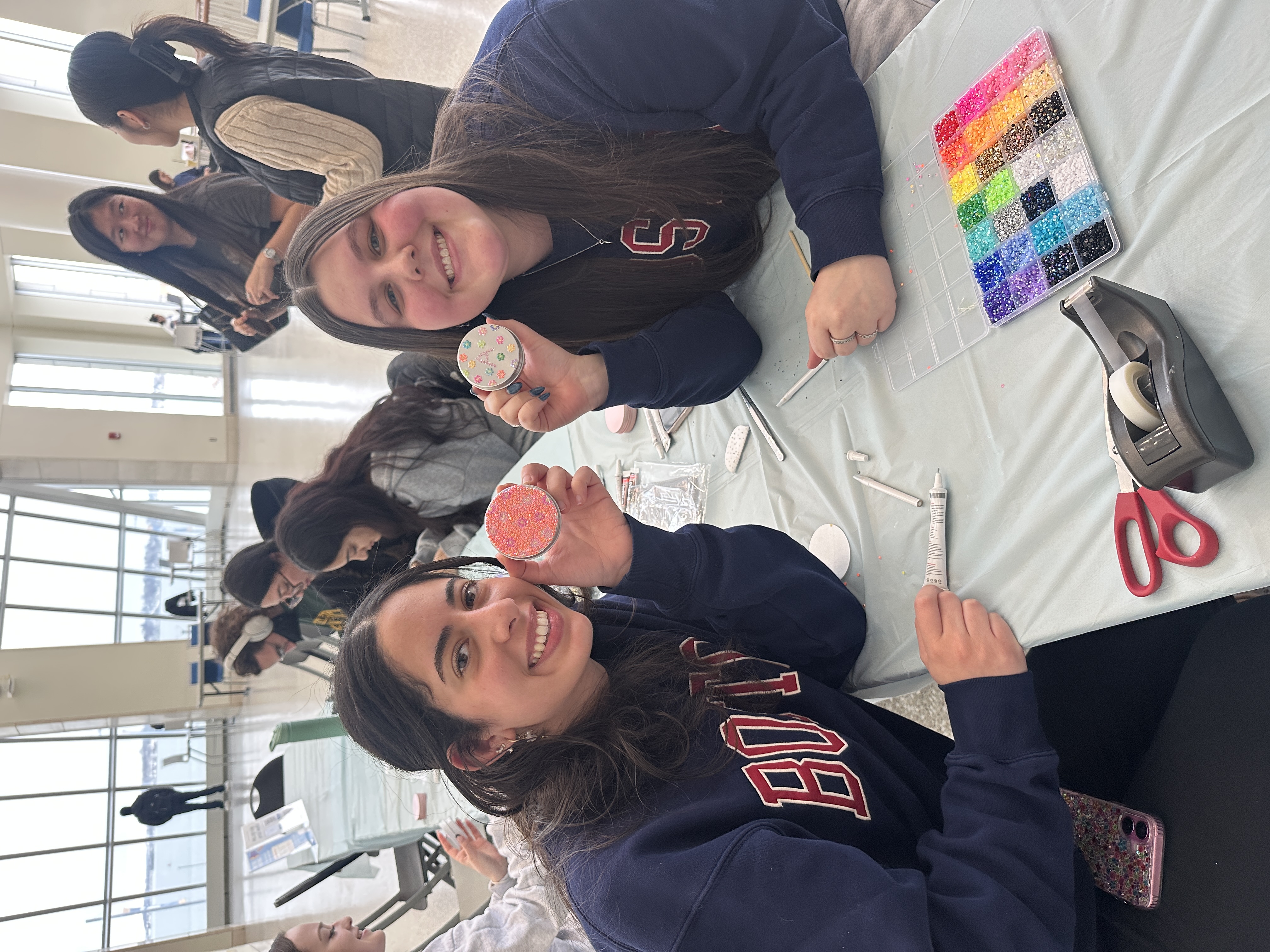 2 students holding up craft