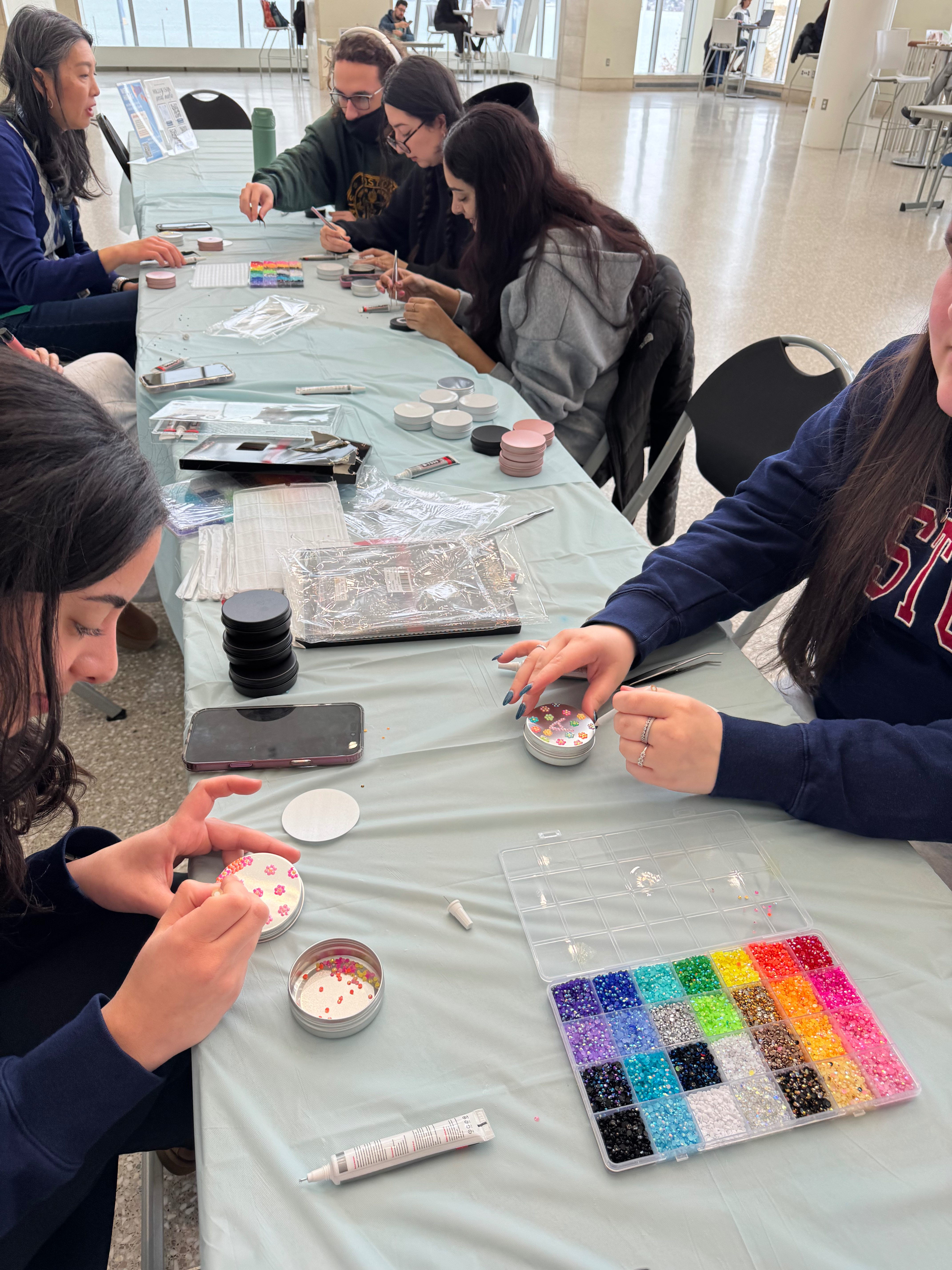table with people doing crafts