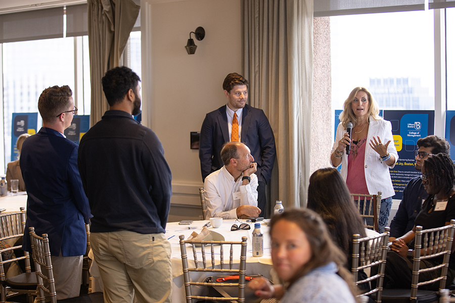 Sandy Lish, principal of the Castle Group, speaks with her student team.