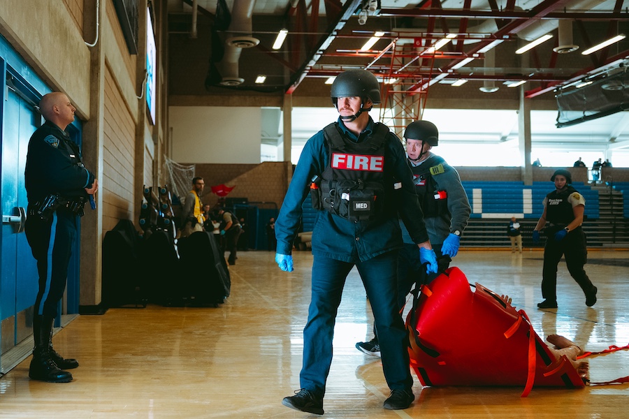 Firefighters carrying mannequin to safe zone during Clark emergency exercise