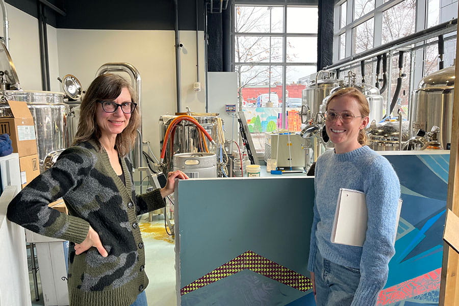 Vesela Veleva and Shelby Ansel smile as they stand in Portico Brewery, during the testing of safer cleaning solutions