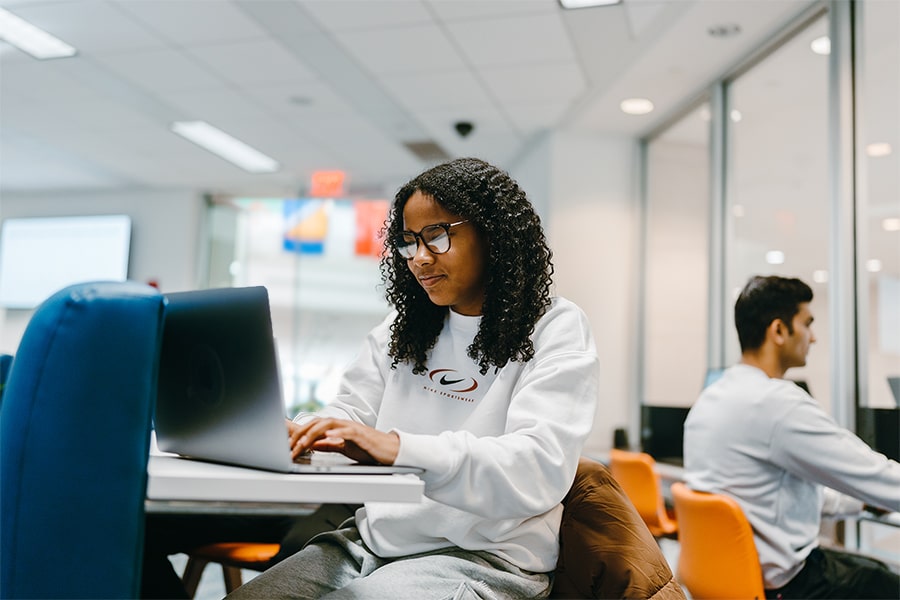 student on laptop in One Stop office