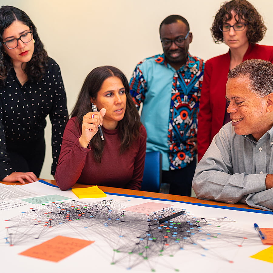 Sustainable solutions colleagues discuss a map.